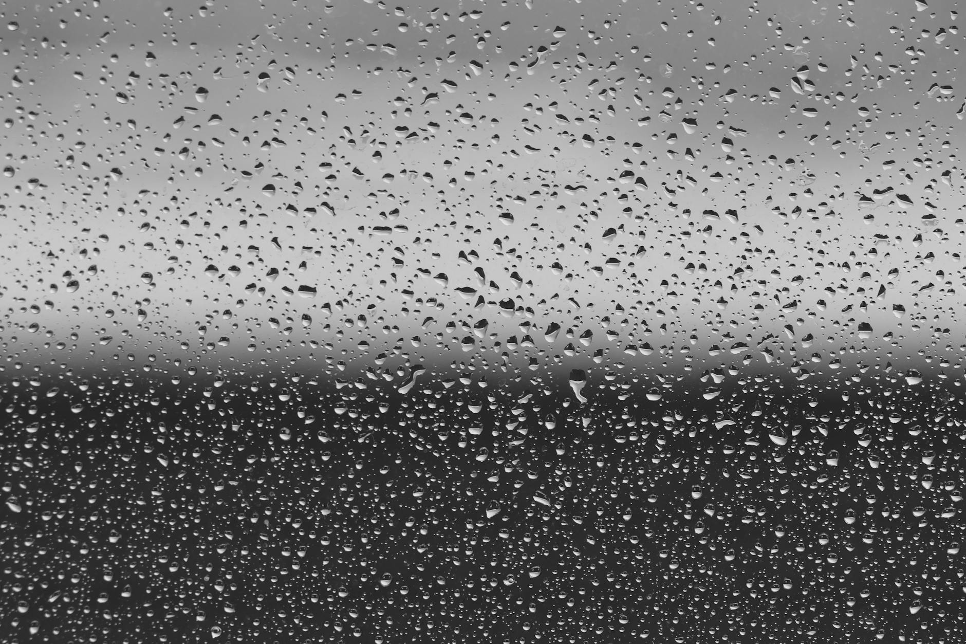 raindrops on window in black and white damp and mould ventilation insulation